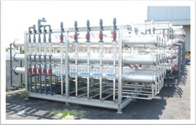 Large rack of reverse osmosis pressure vessels outdoors